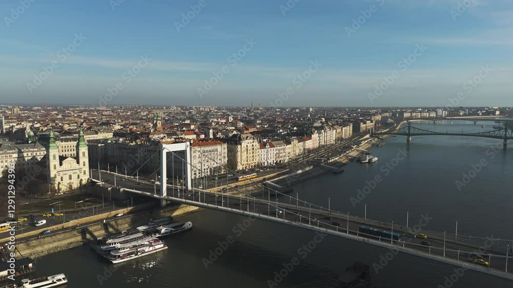 Aerial overview of Budapest Elizabeth Bridge at golden hour, with warm light reflecting off the Danube waters Aerial overview of Budapest Elizabeth Bridge at golden hour, with warm light reflecting off the Danube waters