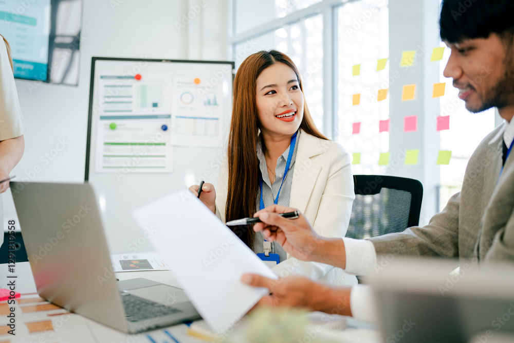 Woman is sitting at a desk with a man and another woman Woman is sitting at a desk with a man and another woman