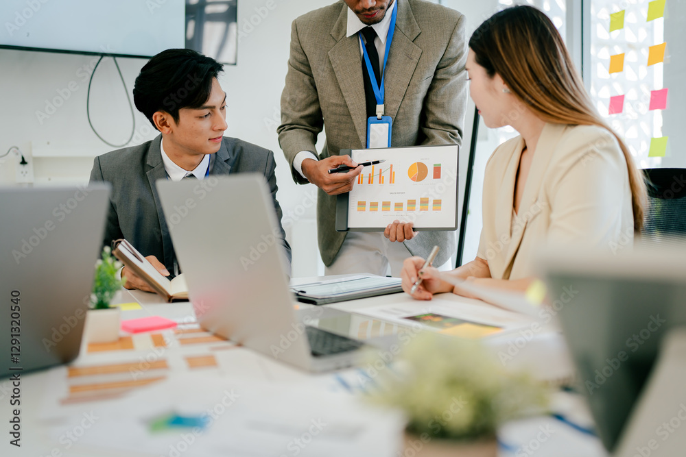 Group of people are gathered around a table with a presentation on a slide Group of people are gathered around a table with a presentation on a slide