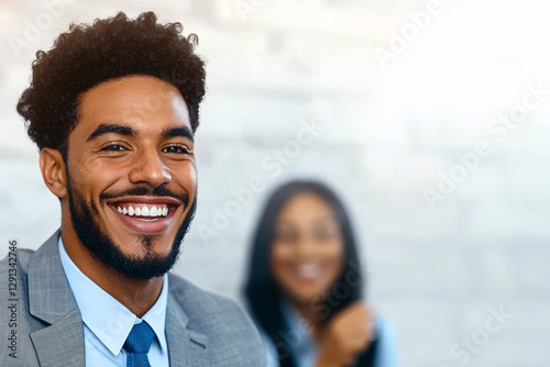A businessman with a beard and a woman in the background