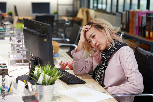 фотографія young businesswoman have a headache from overworked in the office
