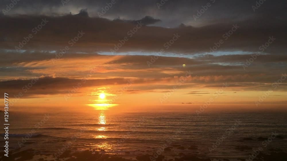 Beautiful colored Sunset with beach, rocks and clouds. Beautiful colored Sunset with beach, rocks and clouds.