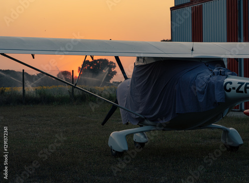 Plane by the agricultural field in a rural aerodrome photo