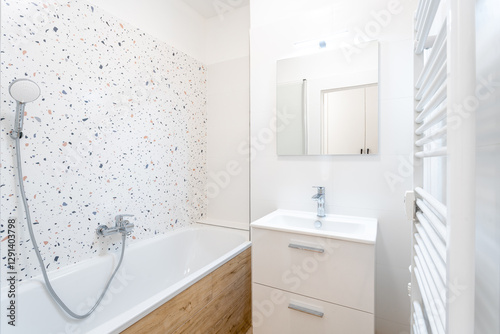 Fényképezés Modern bathroom interior showing bathtub, sink, and heated towel rail
