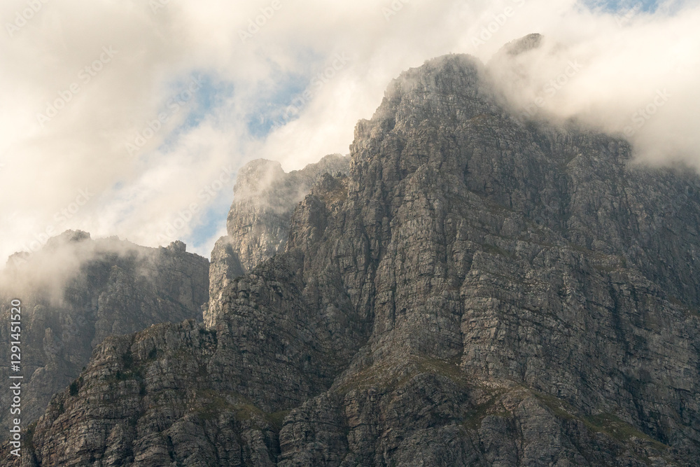 Naklejka premium clouds over mountain peak abstract nature landscape showing rocky cliff face closeup on Jonkershoek, Western Cape, South Africa