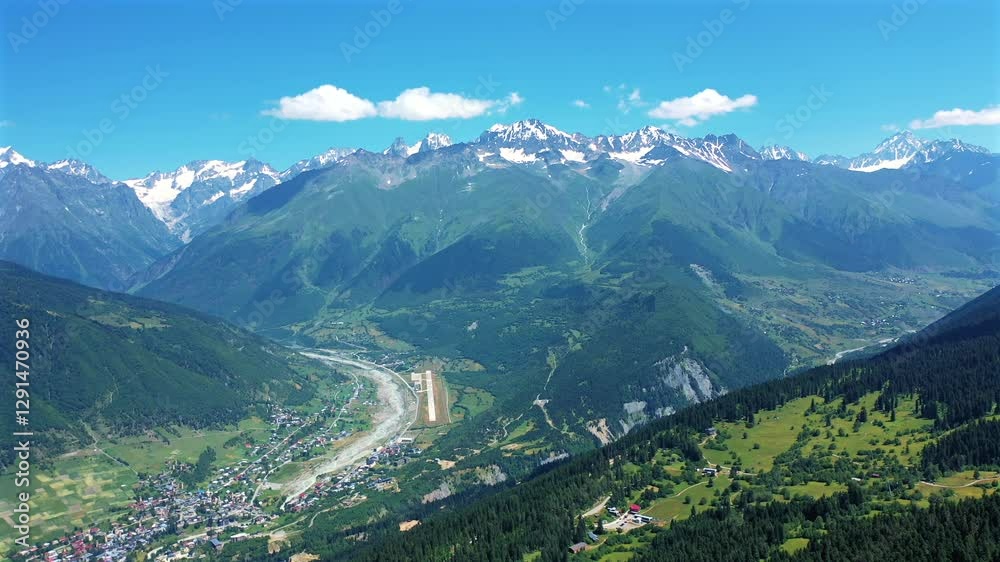 Aerial drone view of the Caucasus mountain range in Svaneti, Georgia, with snowcapped peaks, deep valleys, and traditional villages. Stunning nature ideal for travel, tourism, and adventure content. Aerial drone view of the Caucasus mountain range in Svaneti, Georgia, with snowcapped peaks, deep valleys, and traditional villages. Stunning nature ideal for travel, tourism, and adventure content.