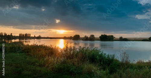 Panoramic view of Dramatic Sunset Over a Serene Lake