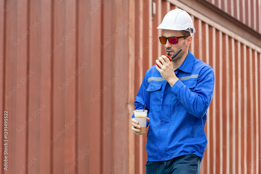 Engineer man walking at shipping yard, Warehouse worker using walkie talkie and talking about work in cargo containers Engineer man walking at shipping yard, Warehouse worker using walkie talkie and talking about work in cargo containers