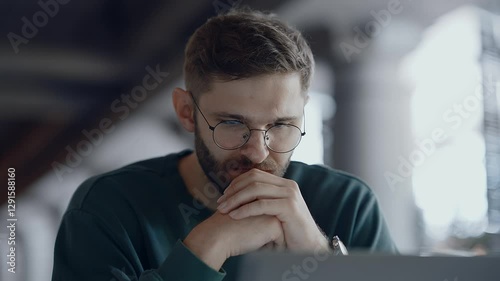 Handsome Bearded Young Adult Man Thinking About Business Development When Working With Laptop
