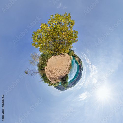 Schilderij op canvas simple little tiny planet without buildings in blue sky with sun and beautiful clouds