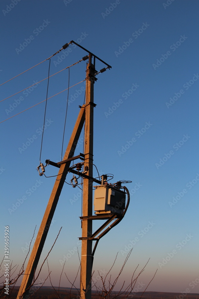 A tall tower with a box attached to it A tall tower with a box attached to it