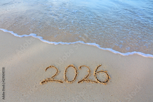 2026 hand written in sand on a beautiful beach
