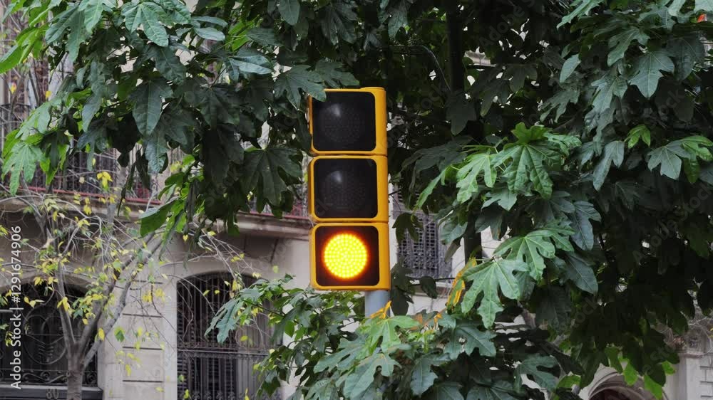 An orange traffic light flashing on a large city road. Modern technologies for the safety of city life. High quality 4k footage