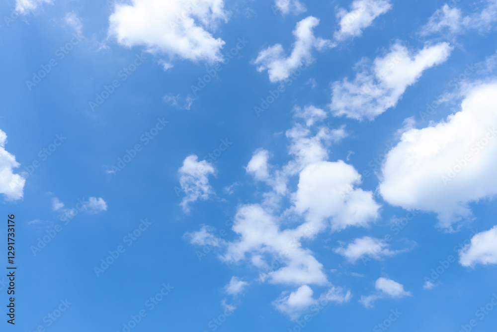 Low angle view of beautiful blue sky with strange shape of fluffy white clouds in the morning or evening in sunny day used as natural background texture in decorative art work Low angle view of beautiful blue sky with strange shape of fluffy white clouds in the morning or evening in sunny day used as natural background texture in decorative art work