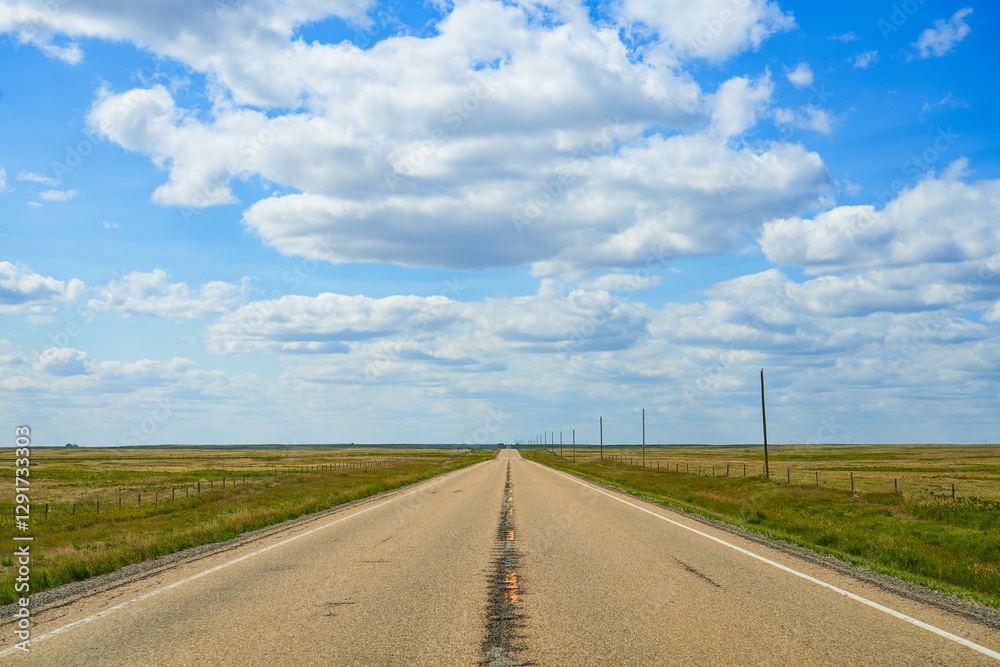 Driving straight on Highway 570 through the flat prairies of Alberta near Drumheller, Canada Driving straight on Highway 570 through the flat prairies of Alberta near Drumheller, Canada