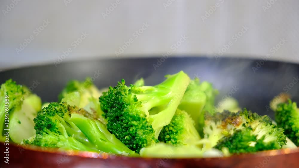 Stewing vegetables, broccoli, celery on cast iron, steaming, cooking process, healthy meal Stewing vegetables, broccoli, celery on cast iron, steaming, cooking process, healthy meal