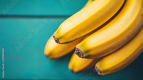 Close-up bunch bananas on teal wooden background photo