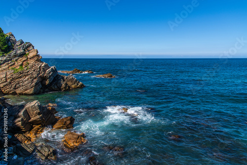 View of the rocky seaside with surf