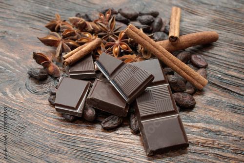 Broken dark chocolate and cocoa beans on the table