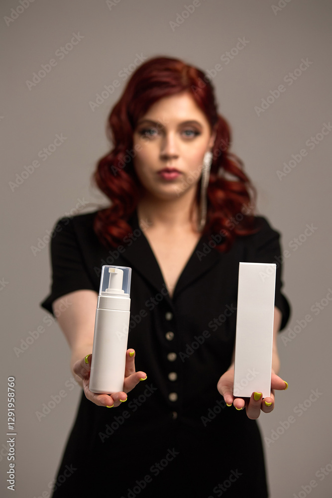 Woman presenting skincare product in white bottle, focus on packaging, blurred background, beauty and cosmetics industry, skincare concept