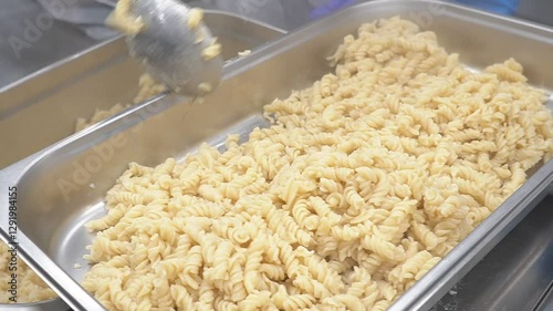 Boiled pasta in a large container in a restaurant