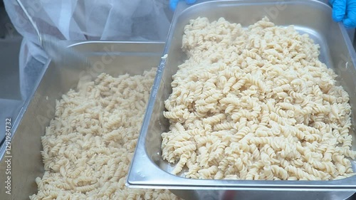Boiled pasta in a large container in a restaurant