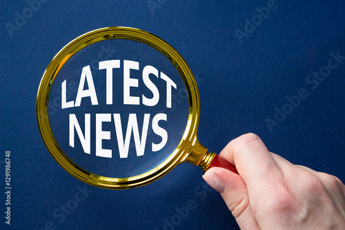 Latest News symbol. Concept word Latest News on magnifying glass. Businessman hand. Beautiful deep blue background. Business and Latest News concept. Copy space