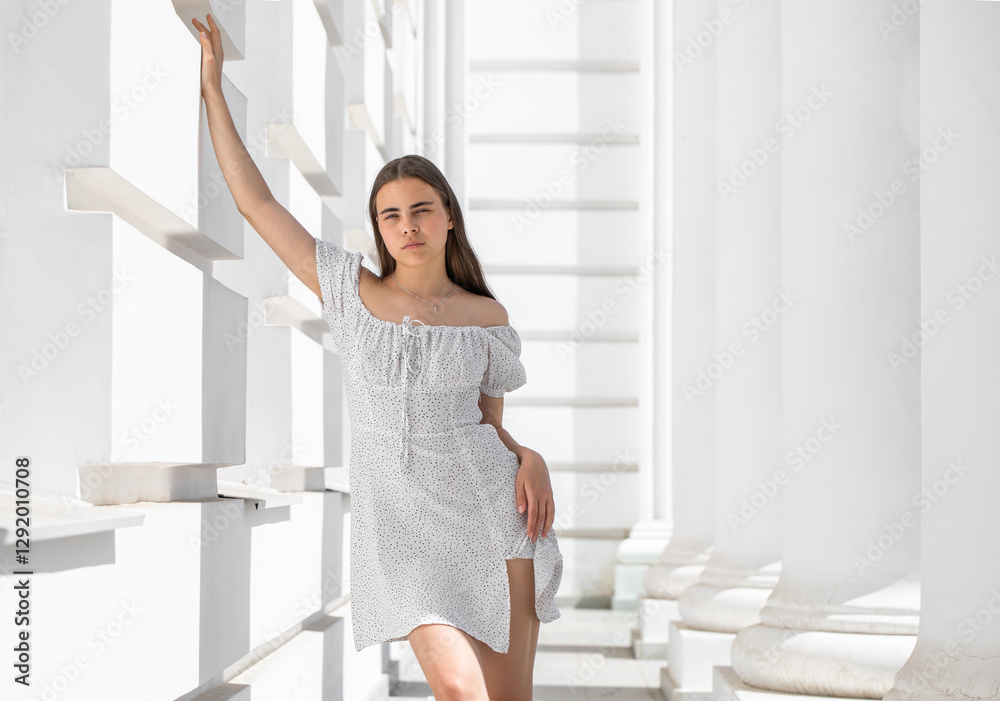 Portrait of a young beautiful brunette woman in a white dress Portrait of a young beautiful brunette woman in a white dress