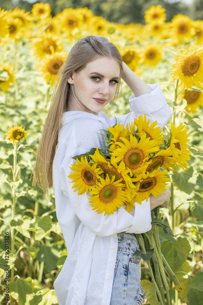 Young beautiful woman with a bouquet of sunflowers Young beautiful woman with a bouquet of sunflowers