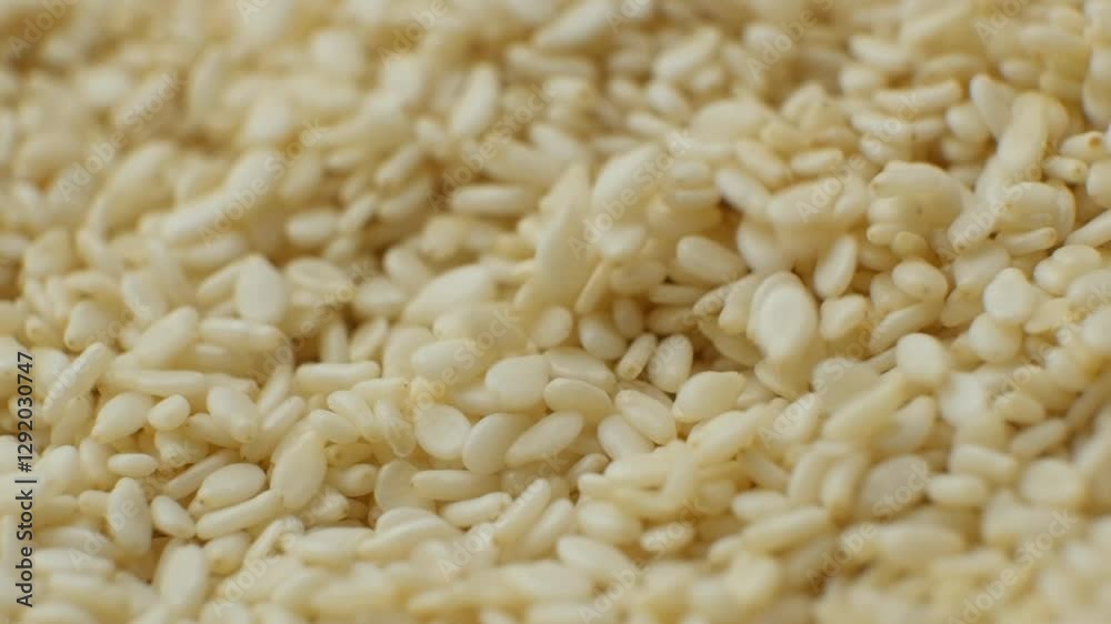 Raw white sesame seeds natural texture slow motion Raw white sesame seeds natural texture slow motion