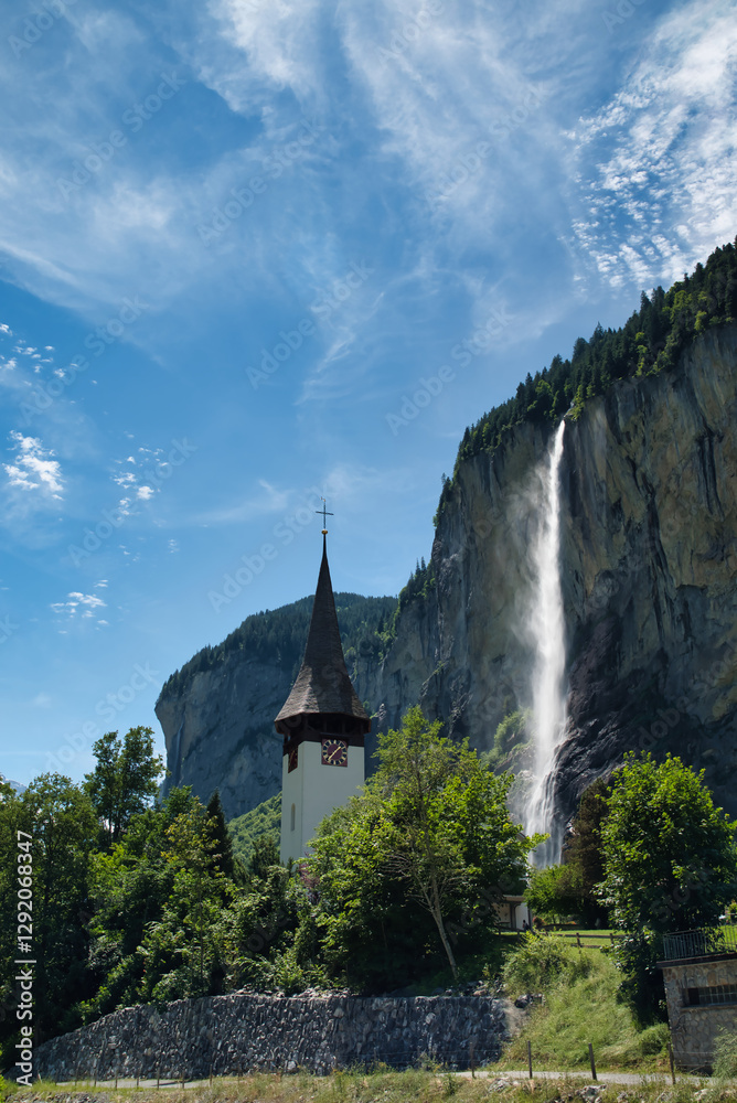 The Staubbach waterfall is a waterfall of the Staubbach and its amazing village with its famous church in Lauterbrunnen, in the Swiss Bernese Oberland region. Vertical The Staubbach waterfall is a waterfall of the Staubbach and its amazing village with its famous church in Lauterbrunnen, in the Swiss Bernese Oberland region. Vertical