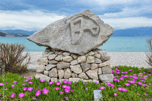 Stone sculpture representing  letter Z. Part of Glagolitic Alphabet Trail Baska. Glagolitic script is the oldest known Slavic alphabet from 9th century photo