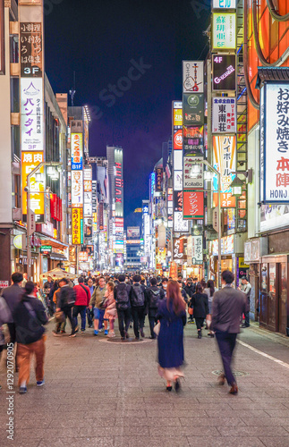 TOKYO, JAPAN - Mar 31, 2023: Crowds pass through Kabukicho in the Shinjuku district. The area is an entertainment and red-light district.
