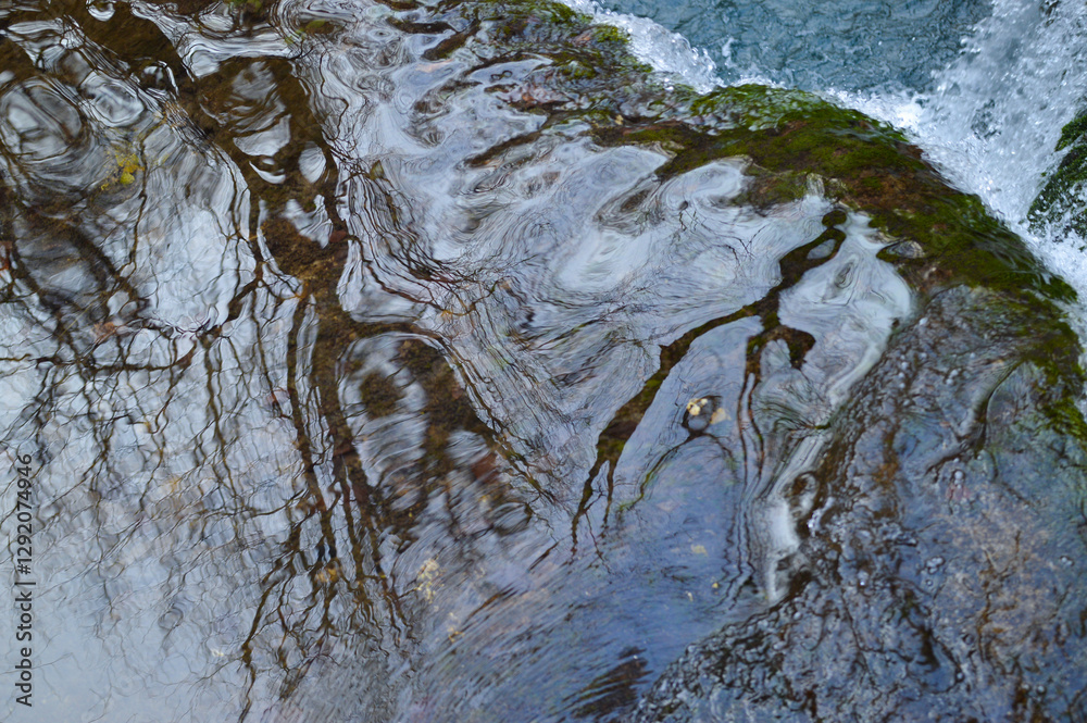 Obraz premium Close up river water reflection near waterfall. Slapnica river, Žumberak, Croatia