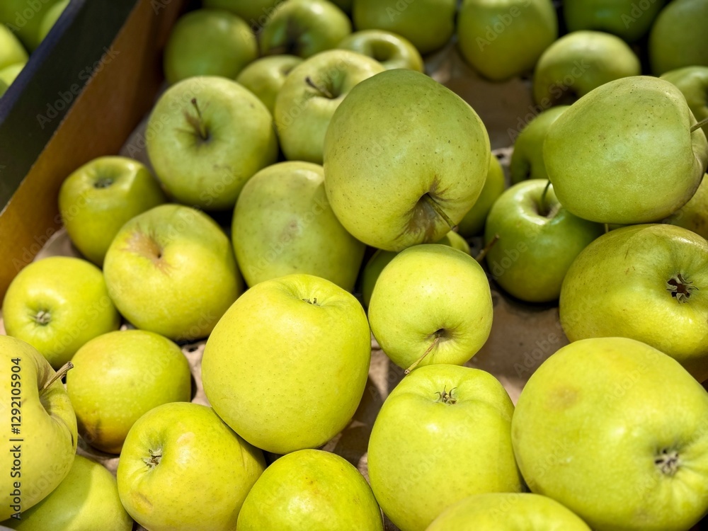 A vibrant and colorful display of fresh, crisp green apples organized neatly in a bustling market settings. Close-up A vibrant and colorful display of fresh, crisp green apples organized neatly in a bustling market settings. Close-up