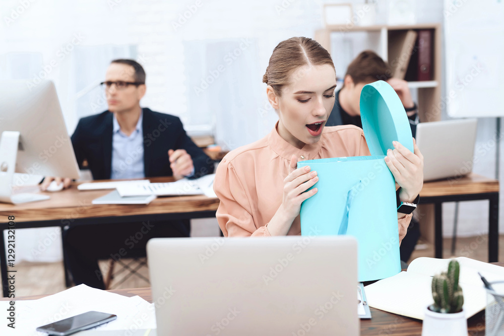 Young woman relaxes at work. She looks at the purchases. Young woman relaxes at work. She looks at the purchases.
