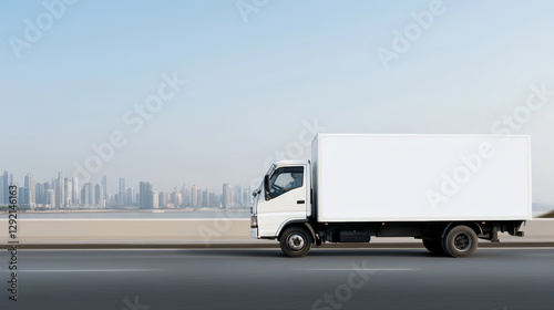 Delivery truck cruising highway lane, unmarked trailer against city skyline, potential advertising space visible
