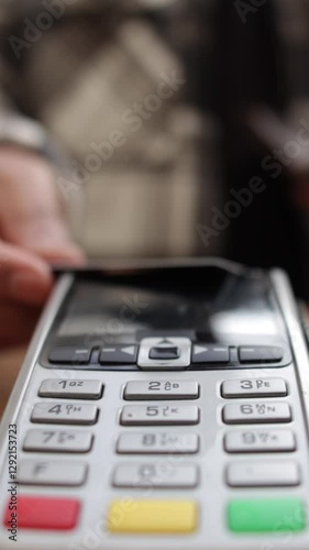 Electronic payment process showing customer using contactless credit card for secure, fast transaction at point of sale terminal in retail environment