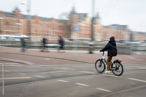 Photography Cyclist riding in the city centre near train station