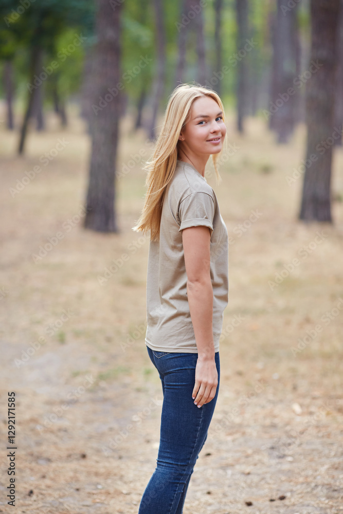 Blonde lady with natural makeup posing in a pine forest. Gorgeous blue eyed caucasian woman in beige t-shirt , enjoying summer vacation. Blonde lady with natural makeup posing in a pine forest. Gorgeous blue eyed caucasian woman in beige t-shirt , enjoying summer vacation.
