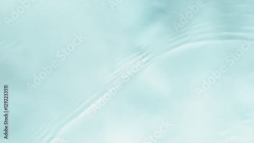 Slow motion of splashing water on light blue background , filmed on high speed cinematic camera at 1000 FPS