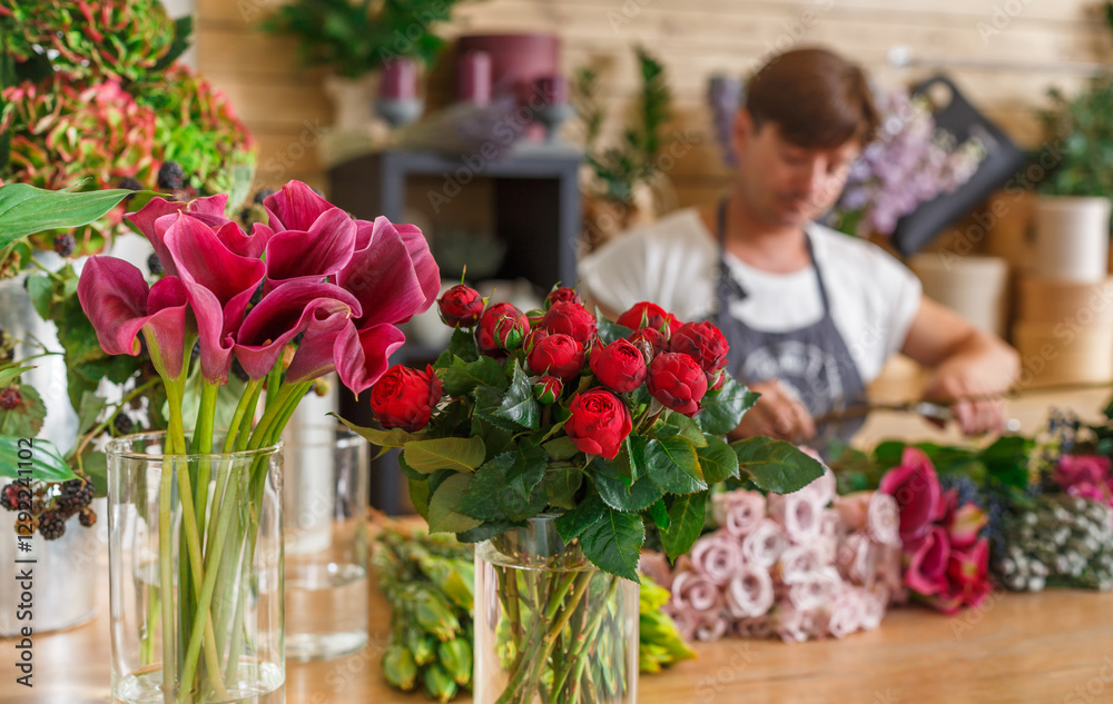 Small business. Male florist unfocused in flower shop. Floral design studio, making decorations and arrangements. Flowers delivery, creating order Small business. Male florist unfocused in flower shop. Floral design studio, making decorations and arrangements. Flowers delivery, creating order