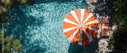 Top view of a beach umbrella accompanied by chairs and beach accessories on a blue background, symbolizing summer vacation