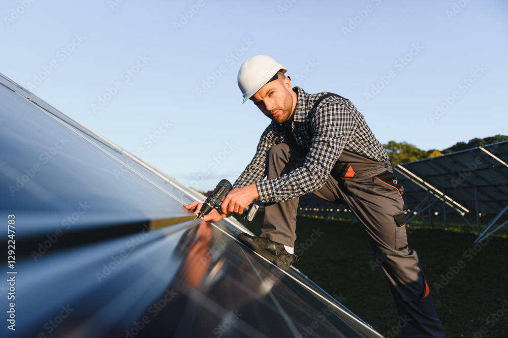 Worker installing solar panels outdoors Worker installing solar panels outdoors