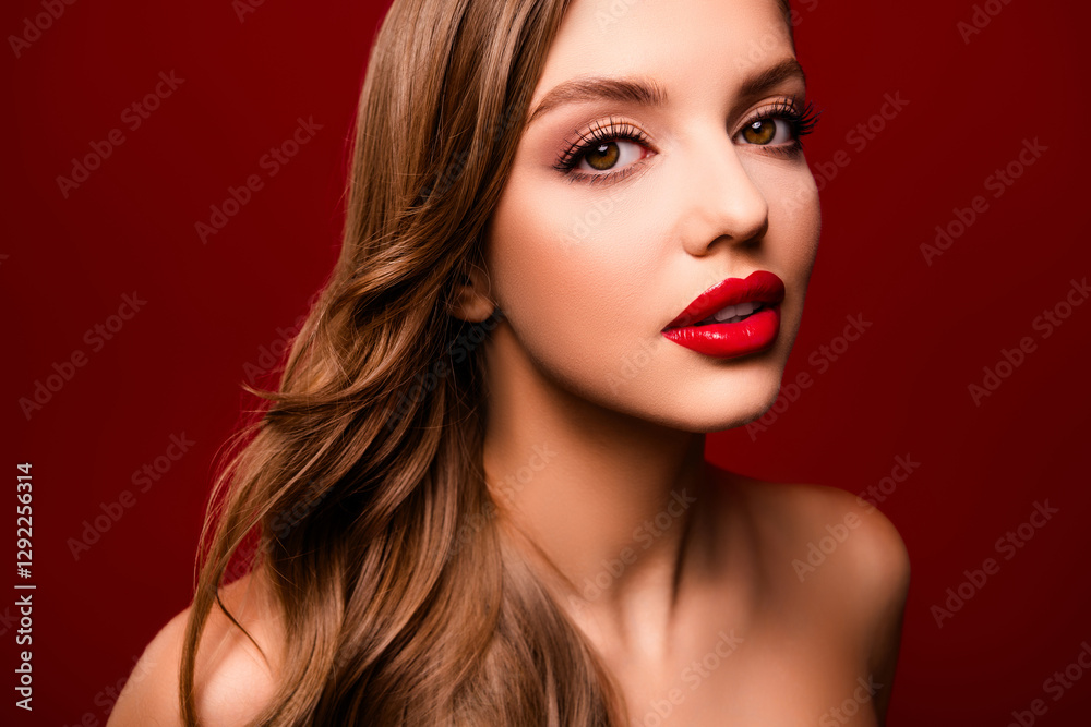 Photo of pretty lady with bright make up pomade having curly brown hairdo looking on red color background Photo of pretty lady with bright make up pomade having curly brown hairdo looking on red color background