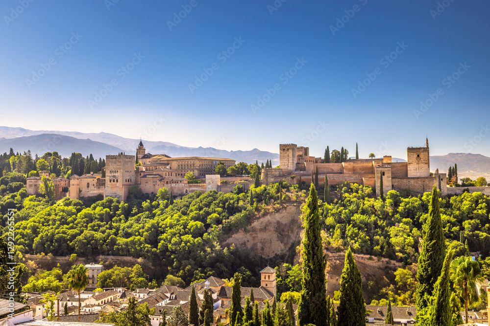 Panorama of the Alhambra from the Mirador de San Nicolas viewpoint in Granada town in Spain. Ancient fortress nestled on a hilltop, surrounded by lush greenery and overlooking a picturesque landscape. Panorama of the Alhambra from the Mirador de San Nicolas viewpoint in Granada town in Spain. Ancient fortress nestled on a hilltop, surrounded by lush greenery and overlooking a picturesque landscape.
