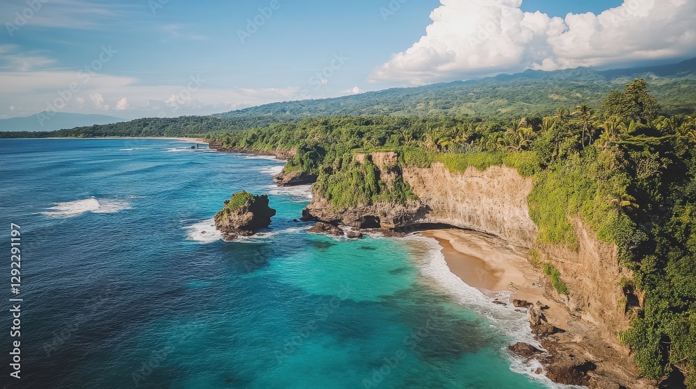 Fototapeta premium Aerial view of a serene tropical coastline with lush greenery and gentle waves under a blue sky