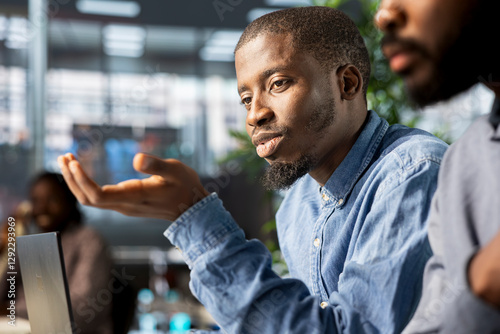African american corporate team focuses on data management, planning strategies for company growth and aligning business goals with performance metrics for measurable success.