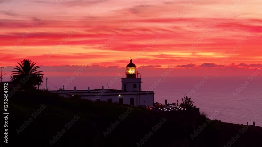 Stunning aerial view of a lighthouse against a vibrant sunset over the ocean Stunning aerial view of a lighthouse against a vibrant sunset over the ocean