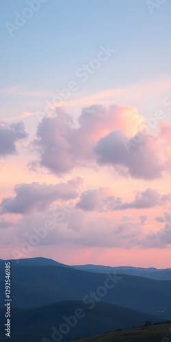  Fluffy Clouds in Soft Gradient Hues Stretch Across the Sky, Creating a Peaceful Evening Scene